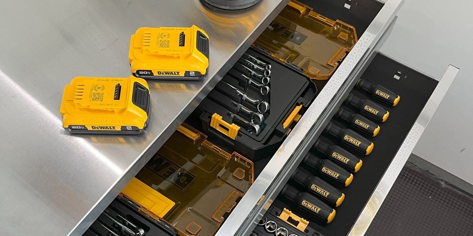 An open drawer inside a WorkBOX holding organized socket sets, screwdrivers and spare batteries
